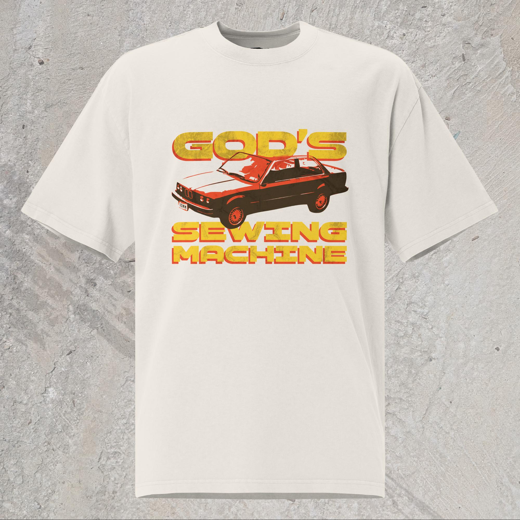 10mm funny car graphic white oversized T-shirt displaying BMW E30 with yellow text that reads “GOD’S SEWING MACHINE”