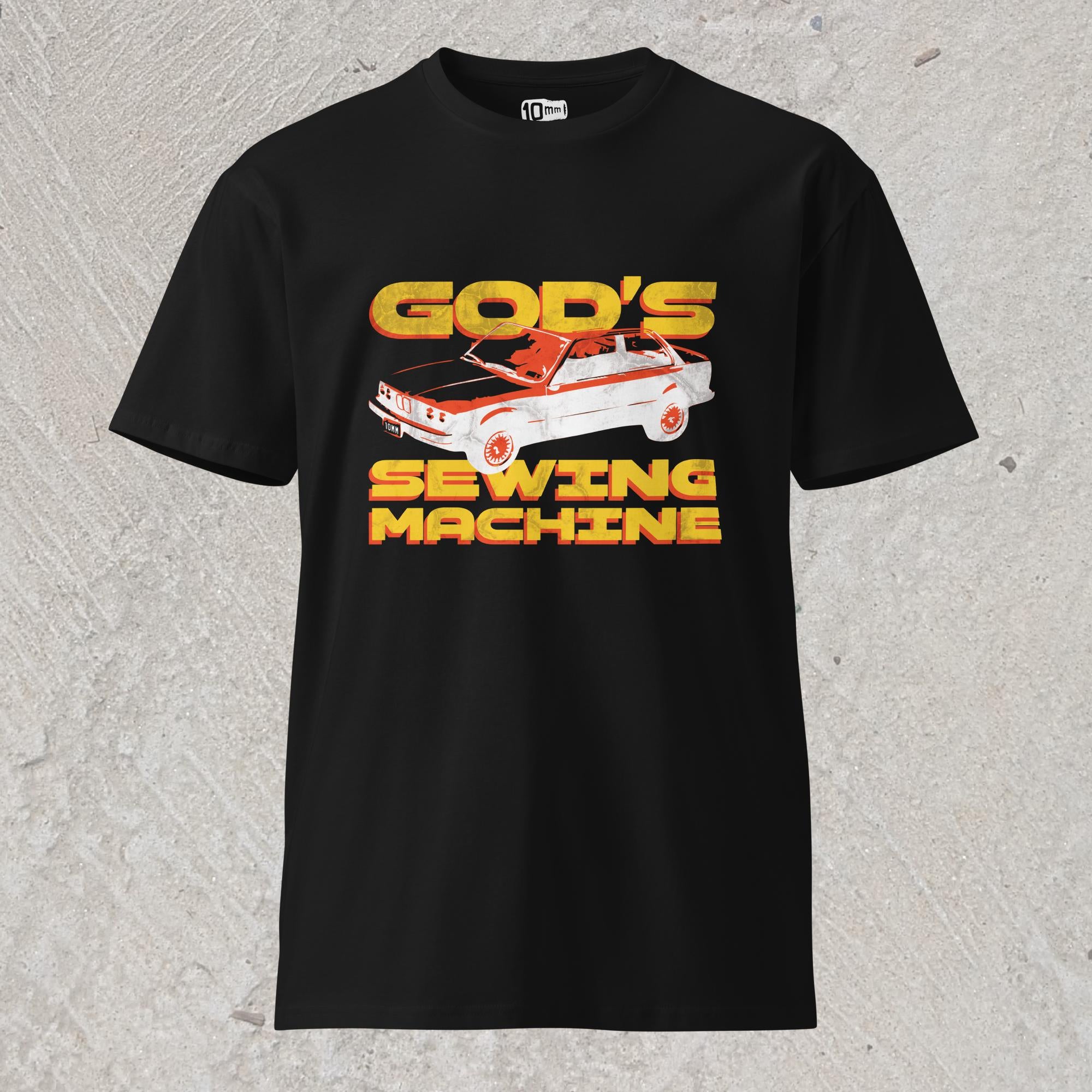 10mm funny car graphic black T-shirt displaying BMW E30 with yellow text that reads “GOD’S SEWING MACHINE”