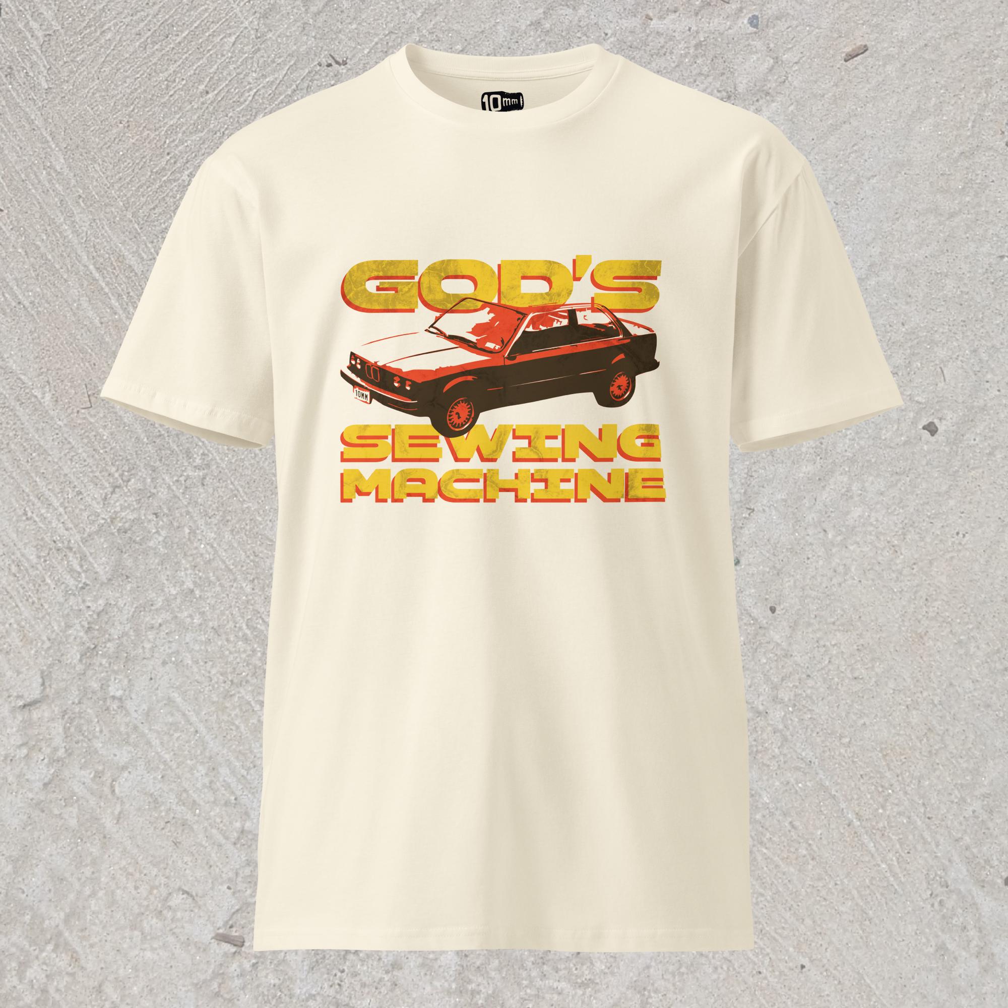 10mm funny car graphic cream colored T-shirt displaying BMW E30 with yellow text that reads “GOD’S SEWING MACHINE”
