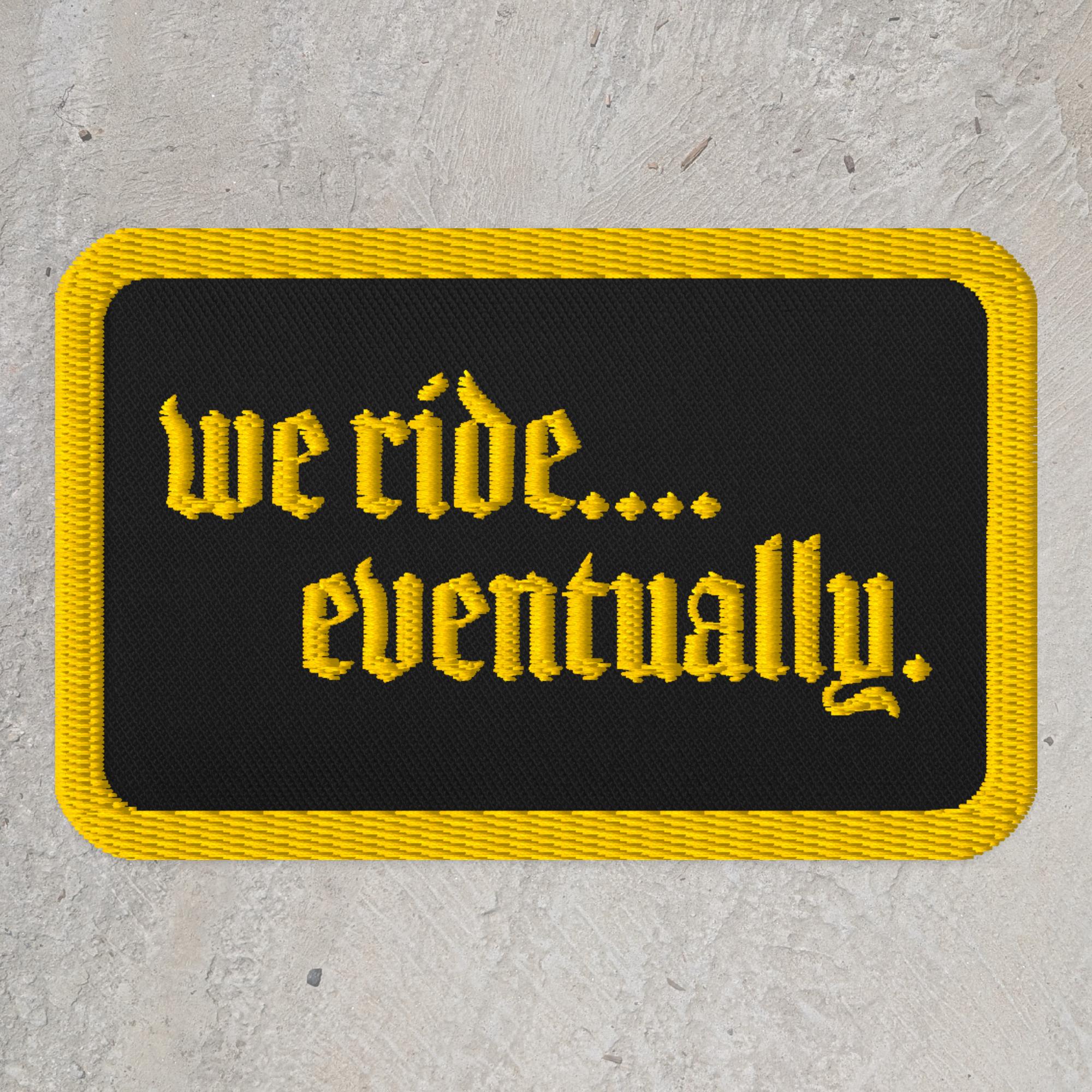 Black embroidered rectangle patch with text that reads "we ride...eventually"