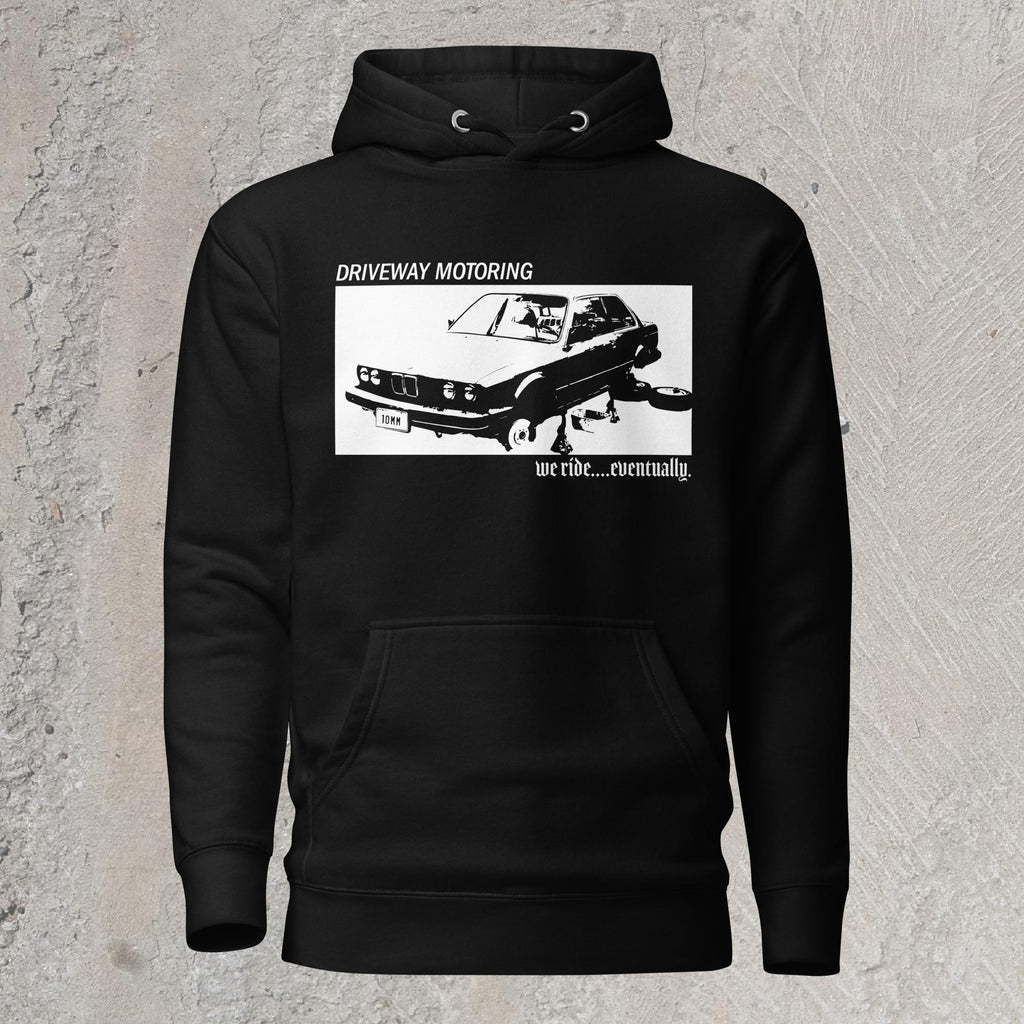 10mm funny graphic black hoodie sweatshirt with BMW car on jack stands with text "Driveway motoring. We ride...eventually"