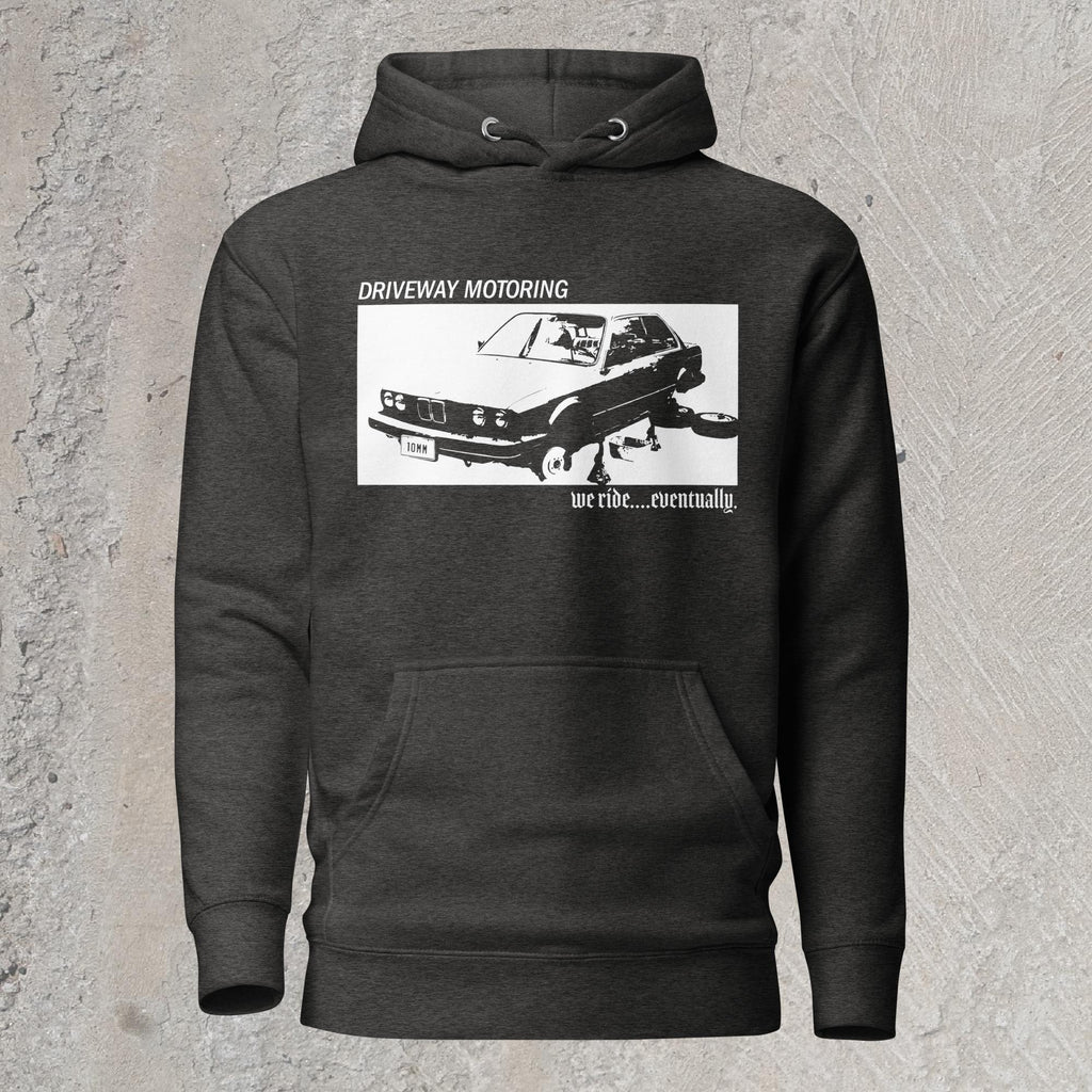 10mm funny graphic charcoal hoodie sweatshirt with BMW car on jack stands with text "Driveway motoring. We ride...eventually"