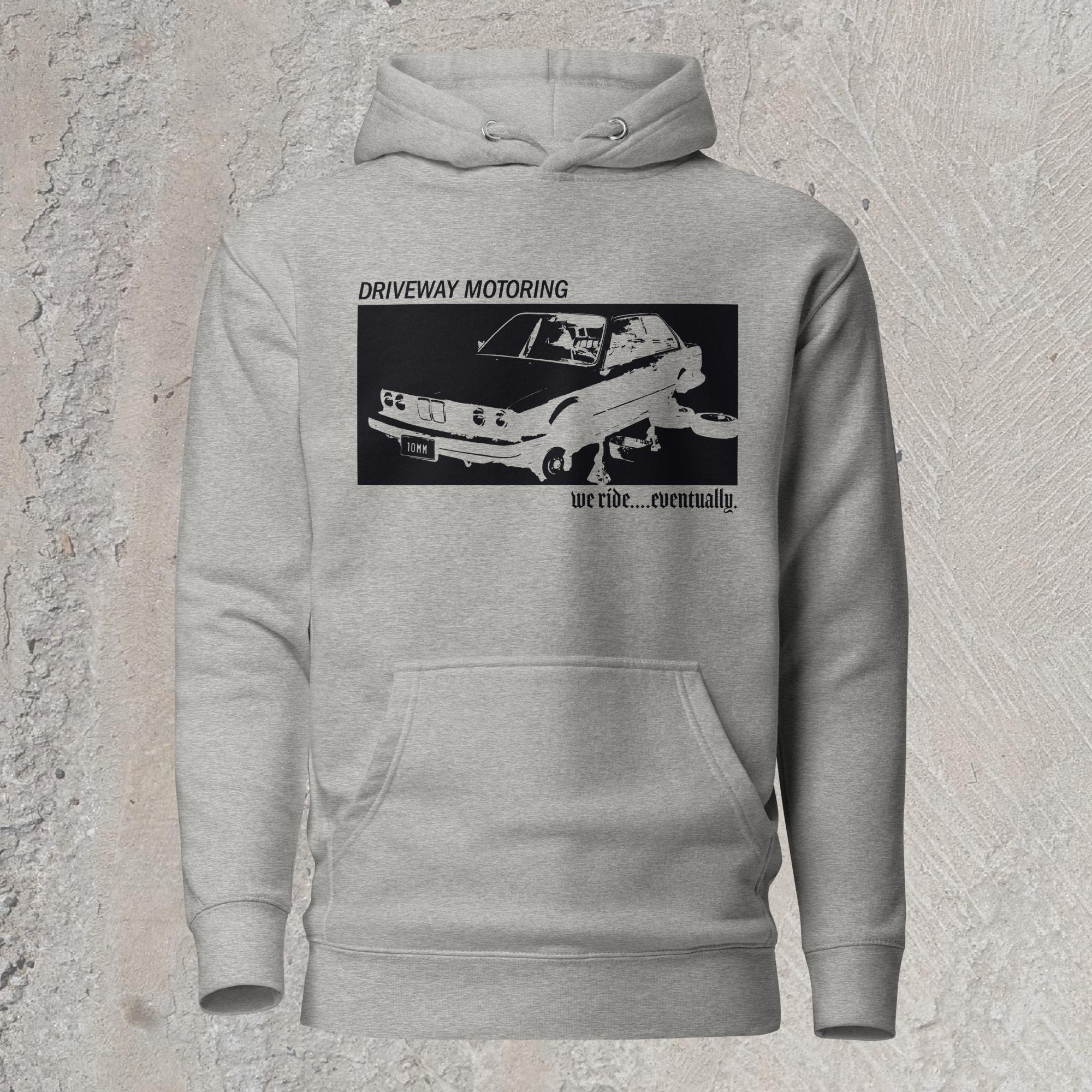 10mm funny graphic gray hoodie sweatshirt with BMW car on jack stands with text "Driveway motoring. We ride...eventually"