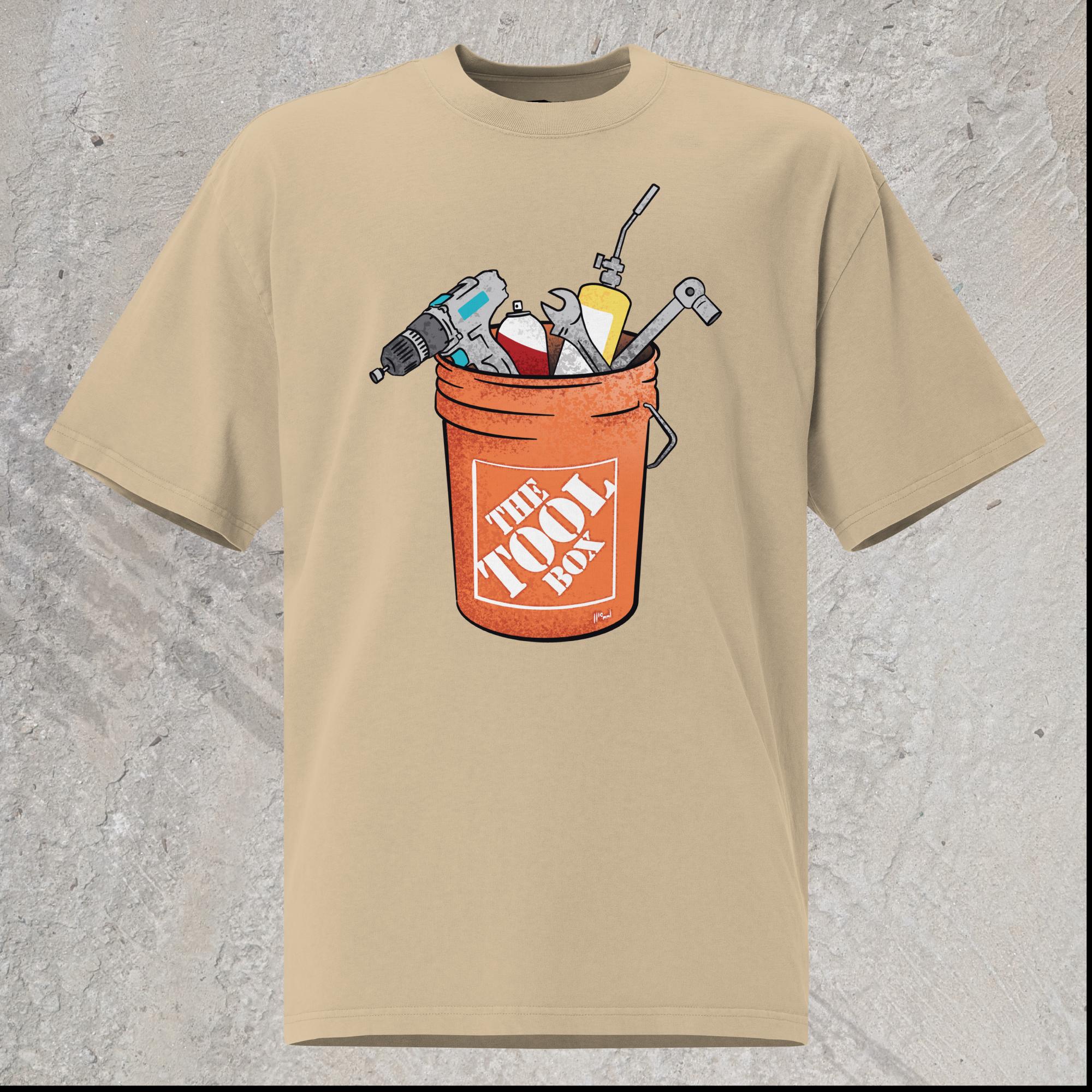 10mm funny graphic khaki oversized T-shirt with orange bucket full of tools for working on cars. Text on bucket reads “The Tool Box”
