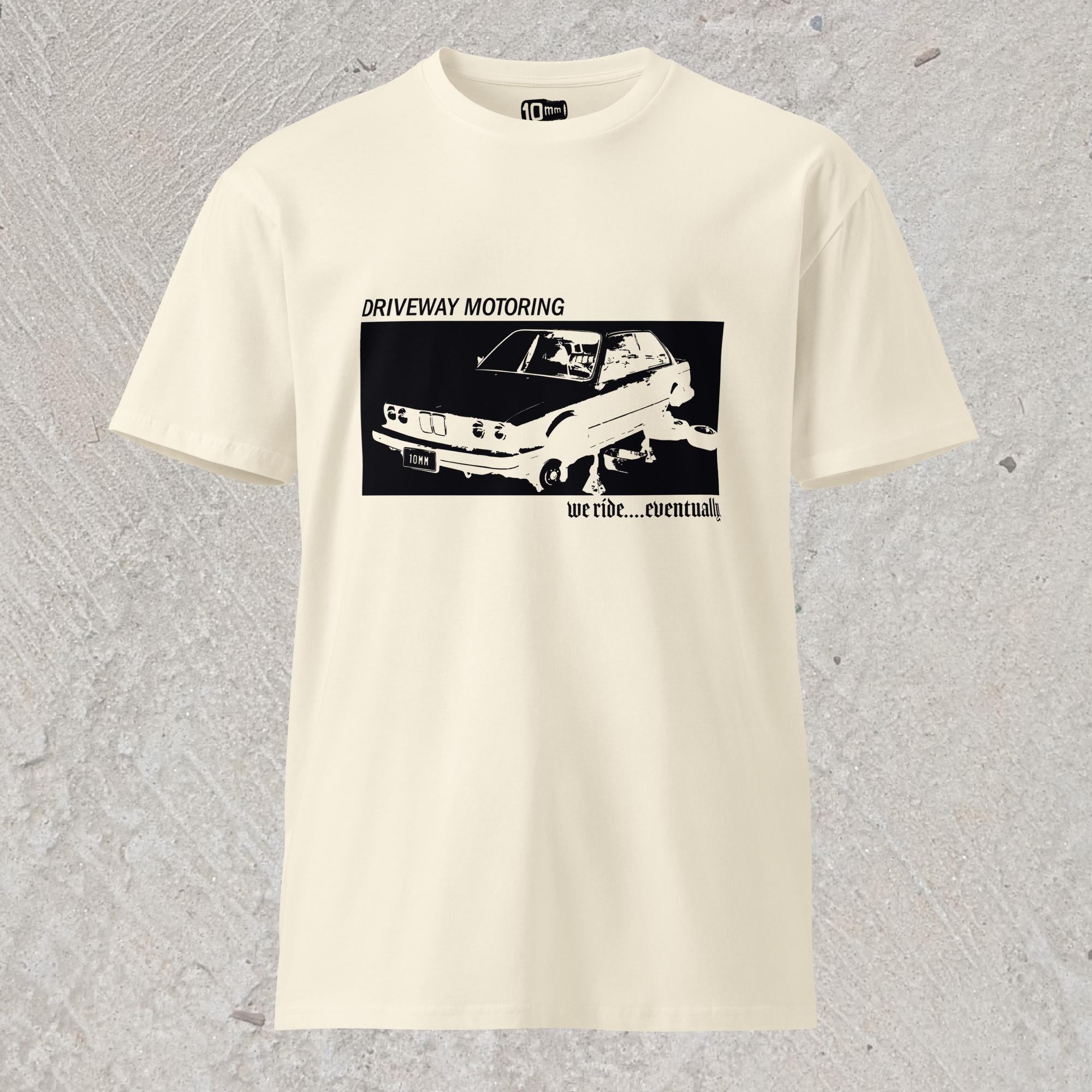 10mm funny graphic off-white T-shirt with BMW car on jack stands with text "Driveway motoring. We ride...eventually"
