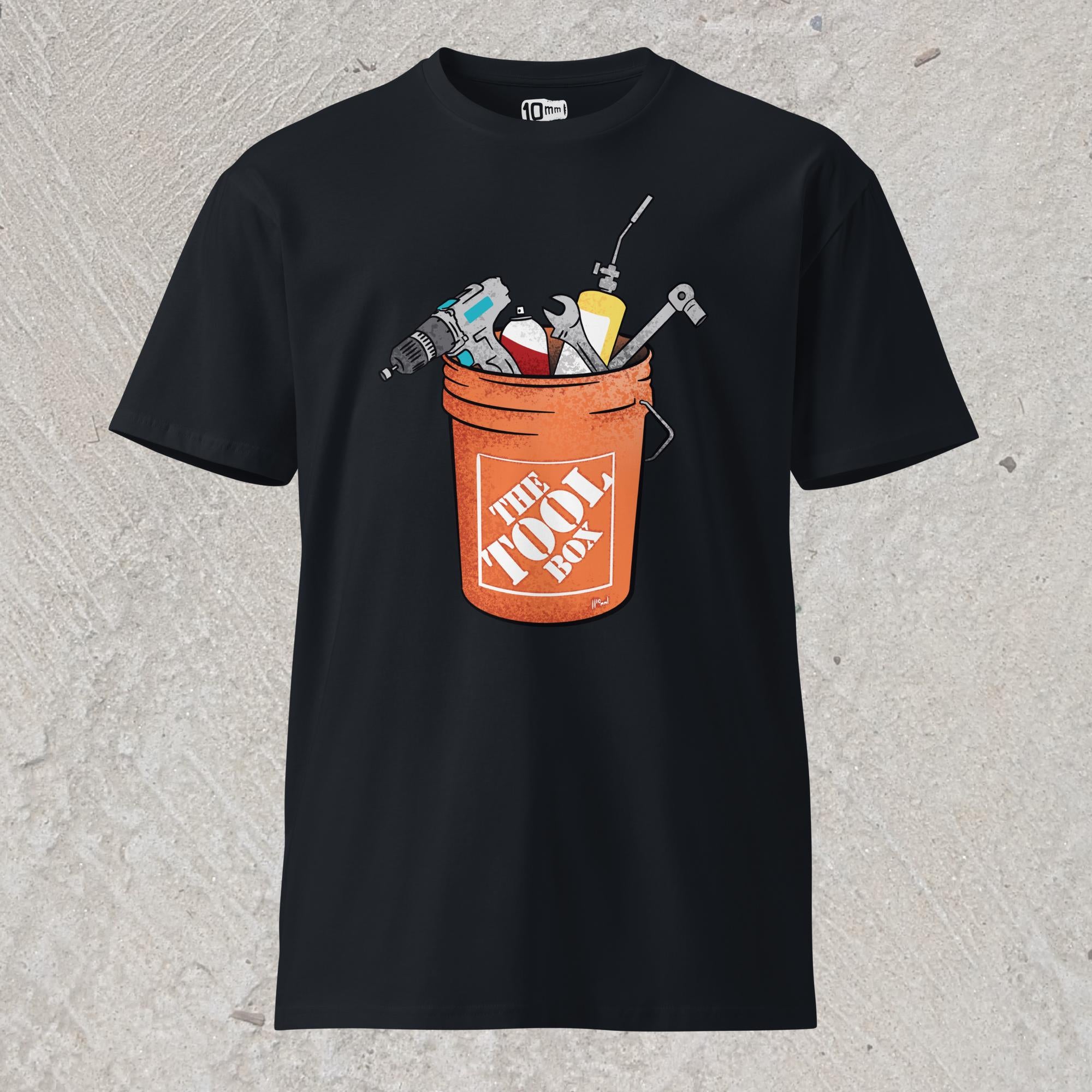 10mm funny graphic navy T-shirt with orange bucket full of tools for working on cars. Text on bucket reads “The Tool Box”