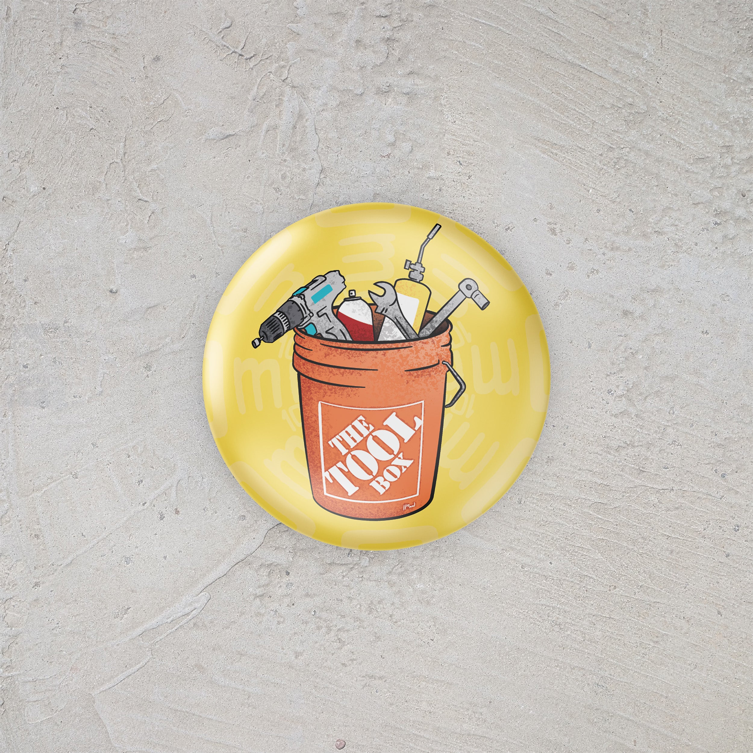 Button badge with a tool bucket and tools on a yellow background