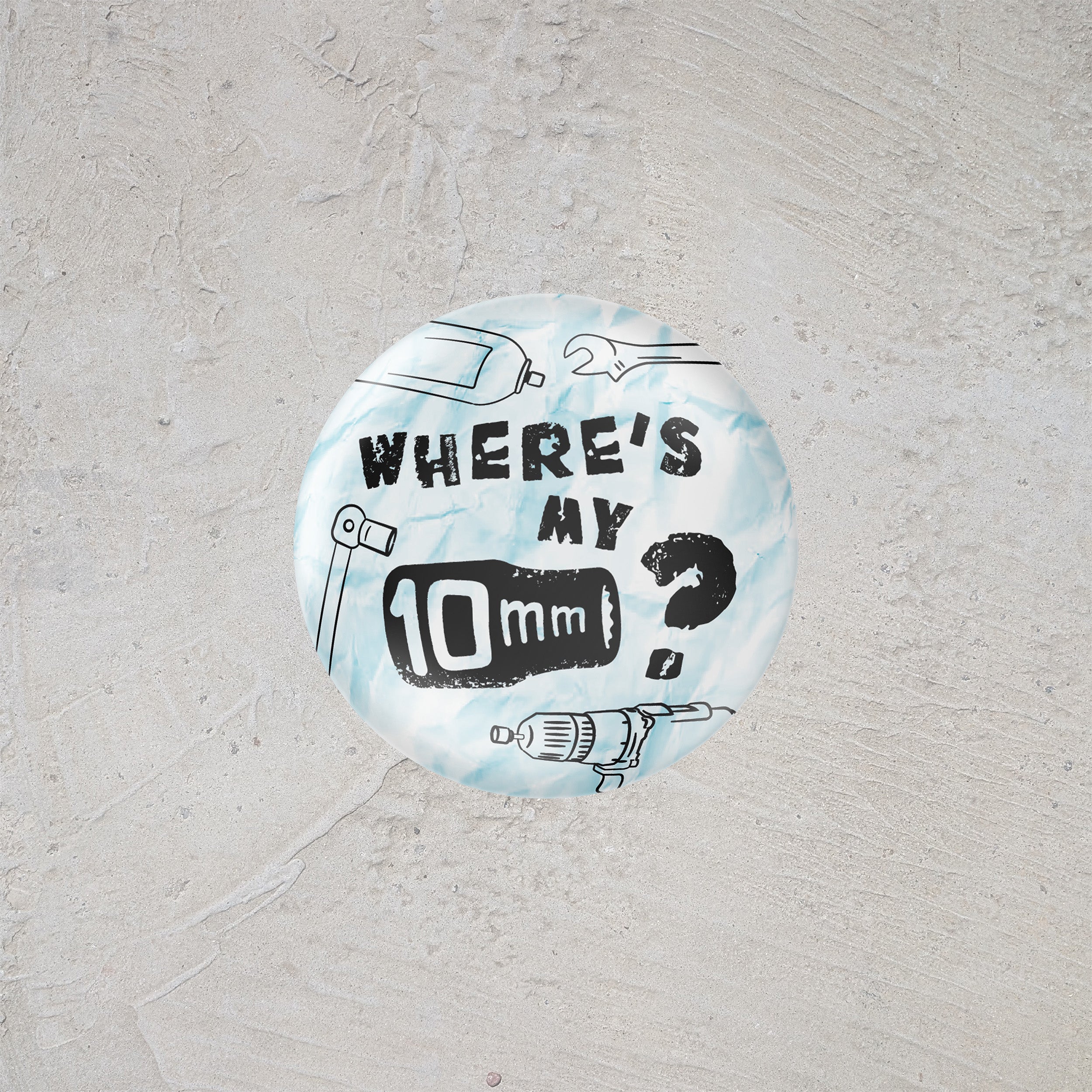 Button badge with text 'Where's my 10mm?' on a light gray background